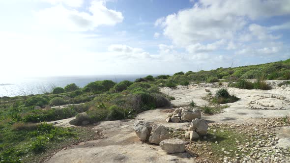 Rocky Limestone Ground with Scarce Greenery near Mediterranean Sea in Gozo Island