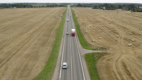 Left Hand Drive Trucks Driving Along a One Lane Motorway alt