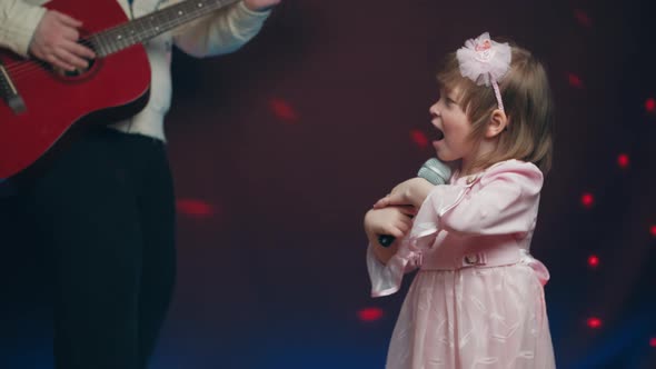 Llittle Girl in Vintage Dress Sings on Stage Her Father Plays Acoustic Guitar alt