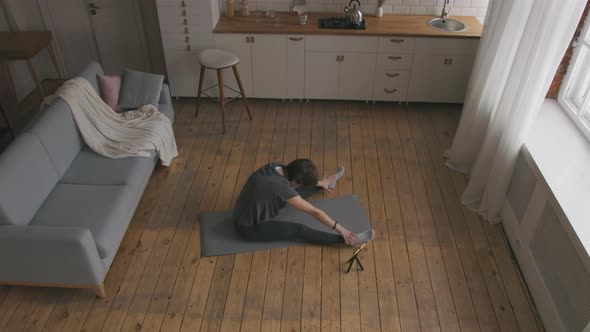 Young Woman Starts her Online Fitness Training alt