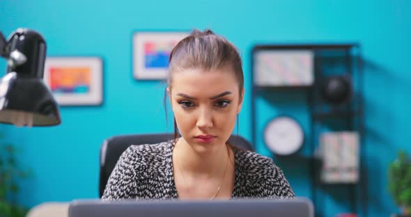 Young Teenage Woman is Studying with a Laptop in Her Room alt