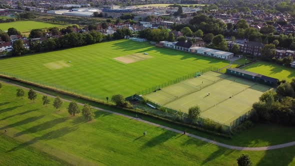 Aerial shot of Canons Park in London with cricket pitch and tennis court alt