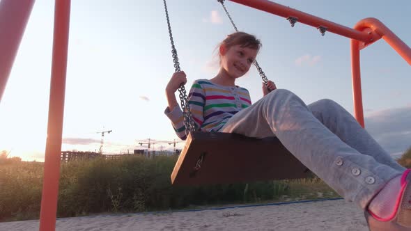 Girl Outdoors On Swing alt