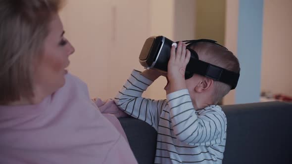 Mother and Son Using 3d Vr Glassed or Helmet