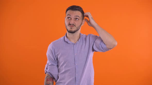 Guilty, Embarrassed Man Scratching Head Thinking and Rolling Eyes Up and Down alt