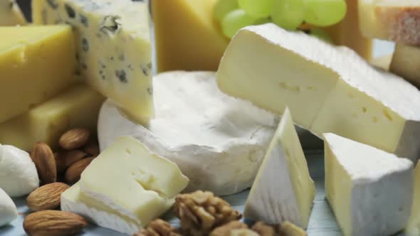 Assorted Different Types of Cheeses with Fruits, Nuts, Dried Fruits
