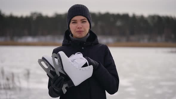 A Young Woman in a Dark Jacket Came To the Frozen Lake To Go Ice Skating alt