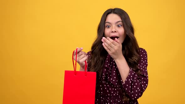 Curious Teen Girl Taking Pop It Antistress Toy From Shopping Bag Gift Showing Thumb Up Gift alt