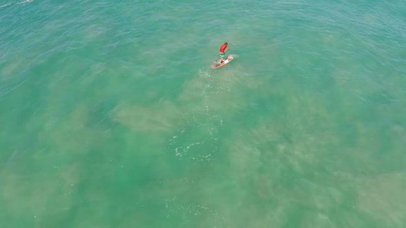 Aerial view of a man sup stand-up paddleboard surfing in Waimea, Hawaii alt