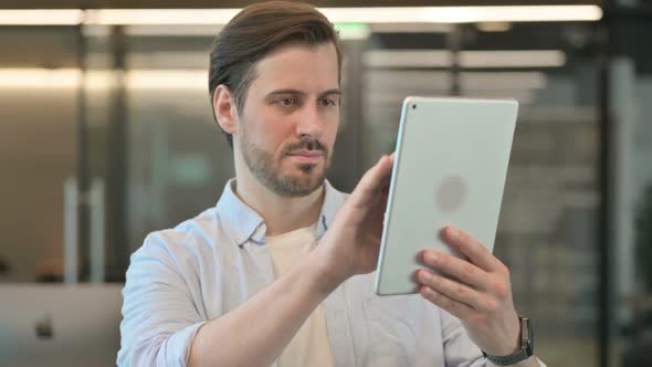 Mature Adult Man Using Digital Tablet Browsing Internet alt
