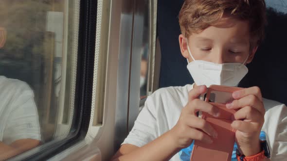 Child Using Mobile Being Bored with the Train Ride