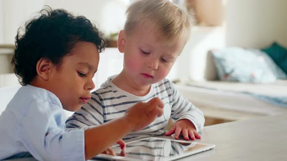 Mixed-Raced Little Boys Learning Digital Tablet at Home