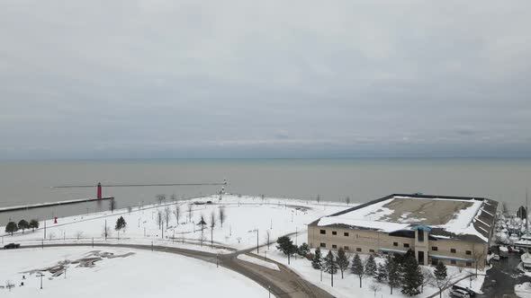 Aerial view toward Lake Michigan with lighthouse and cloudy stormy sky in winter.