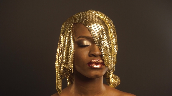 Fashion Portrait Of Glossy African American Woman With Bright Golden Makeup. Bronze Bodypaint, Black