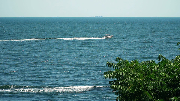 Motor Boat Floating in the Sea. View From the Shore
