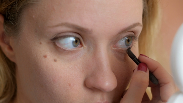 Big Green Eyes Of Young Woman Doing Makeup By Brown Shadows 