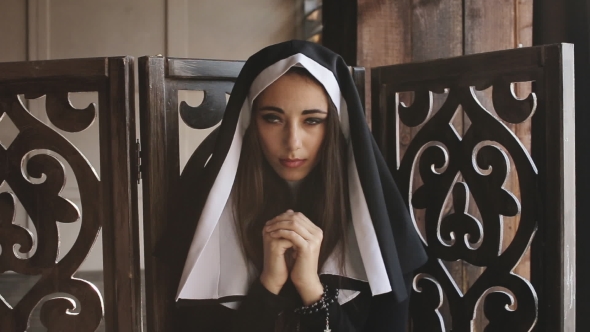 Nun Pray And Looks Into Camera alt