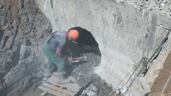 Builder Repairing a Manifold Using Steel Disc Saw
