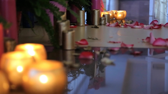 Burning Candles In Glass Vase Stand On Floor. alt