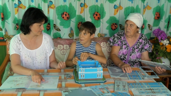 The Family At The Table Playing a Game