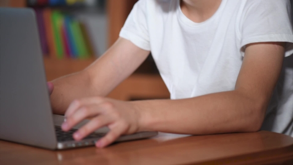 Teen Boy Working On Laptop