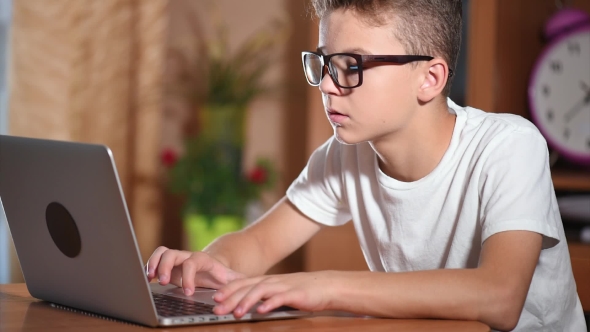 Teen Boy Working On Laptop