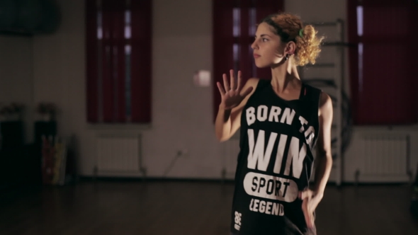 Young Cute Girl Dancing In Dark Studio alt