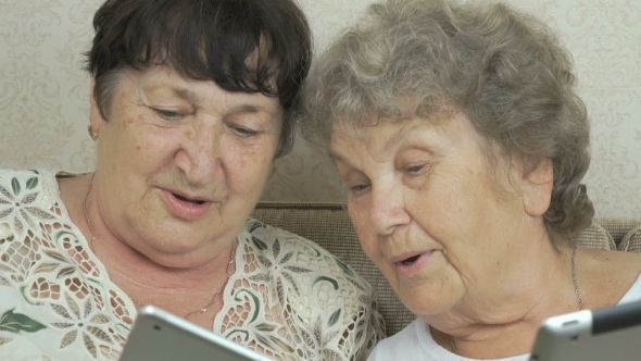 Women Holding The Silver Digital Tablets