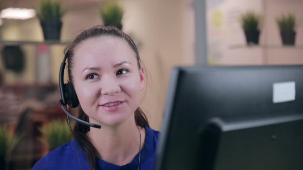 Frendly Woman Talking on the Headset in a Bright Clean Office, Call Center. alt