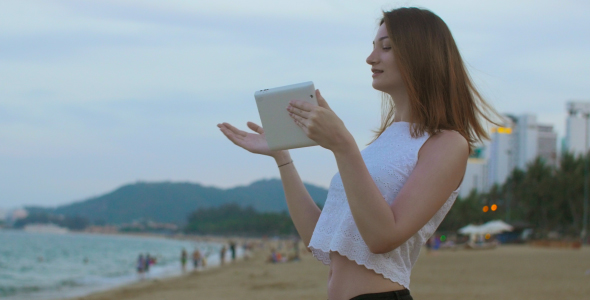 Girl Talking Using Tablet at Seaside