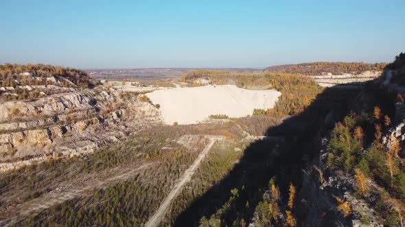 Aerial view of filling the funnel of an old abandoned quarry.