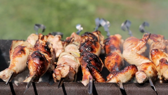 Chicken And Pork Grilled On Charcoal In a Barbecue