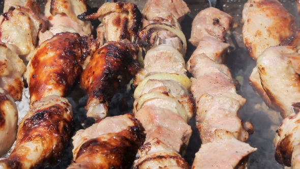 Chicken And Pork Grilled On Charcoal In a Barbecue