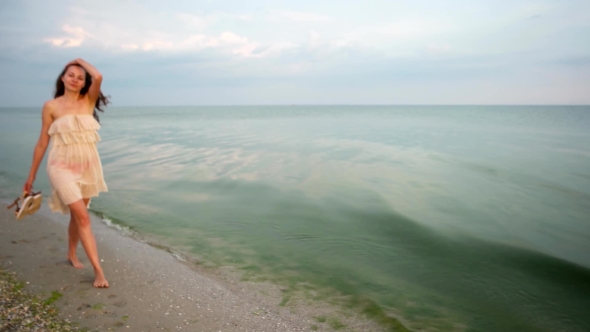 Girl Walking On The Sand At The Beach. alt