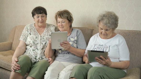 Women Holding The Silver Digital Tablets