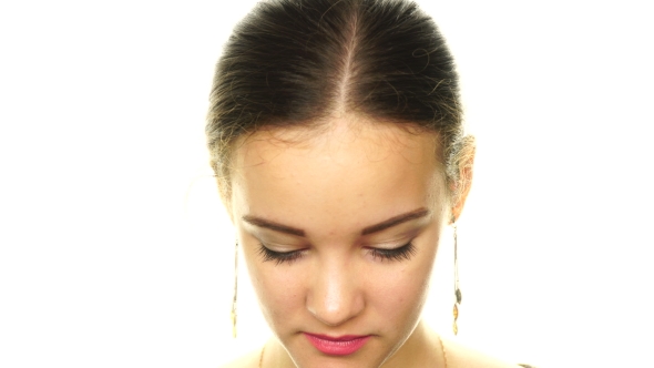 Girl On a White Background Looking At The Camera