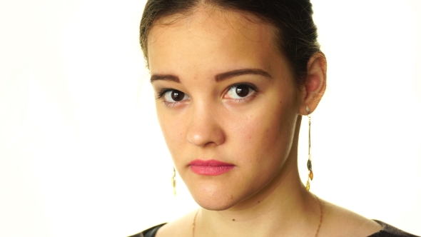 Girl On a White Background Looking At The Camera