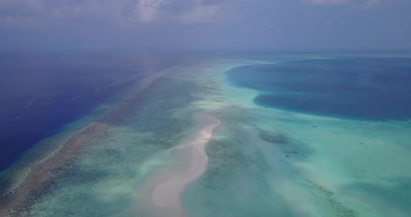 Wide angle above abstract shot of a sandy white paradise beach and aqua turquoise water background  alt