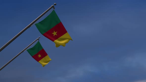 Cameroon flags in the blue sky - 4K