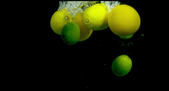 Citrus Fruit In Water On a Black Background alt