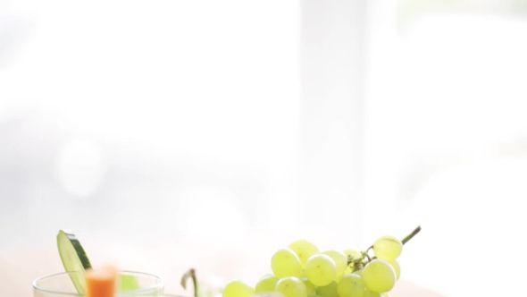 Glasses Of Juice, Vegetables And Fruits On Table alt