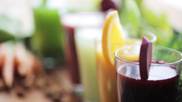 Hand Putting Glass Of Vegetable Juice To Table