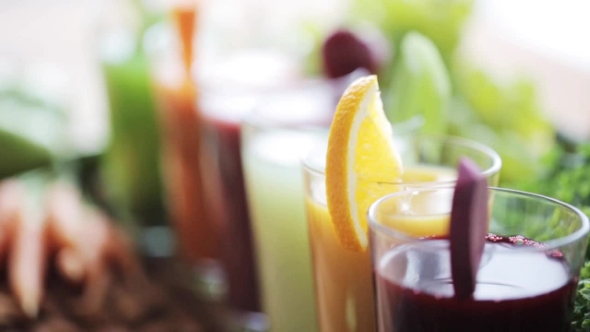 Hand Taking Glass Of Vegetable Juice From Table alt