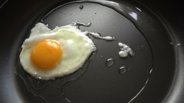 Preparing Scrambled Eggs On Hot Frying Pan