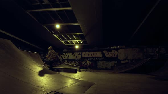 Teen Bmx Rider Racing Up on Bicycle on Ramp in Evening Skate Park alt