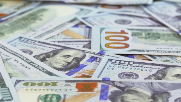 Many 100 US Dollars Bank Notes Rotating Business Background