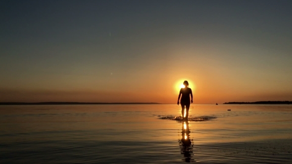 Girl Walks On Water At Sunset