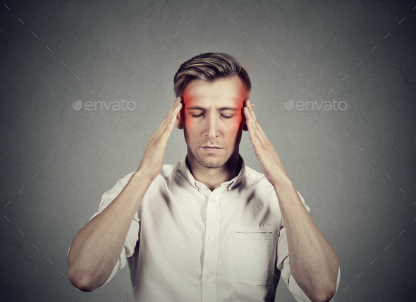 Man with headache thinking very intensely concentrating