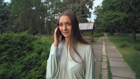 The Girl Is On Track And Talking On The Phone. alt