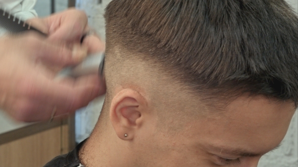 Hairdresser Cutting With Trimmer Hair Of Man Client At Beauty Parlour alt